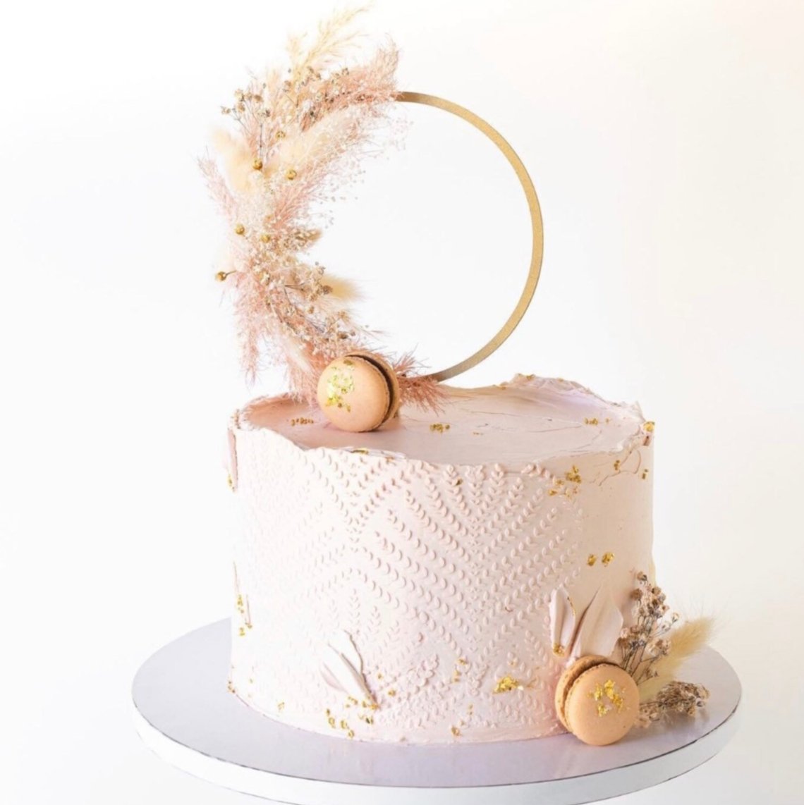 A beautiful boho dry floral hoop birthday cake topper